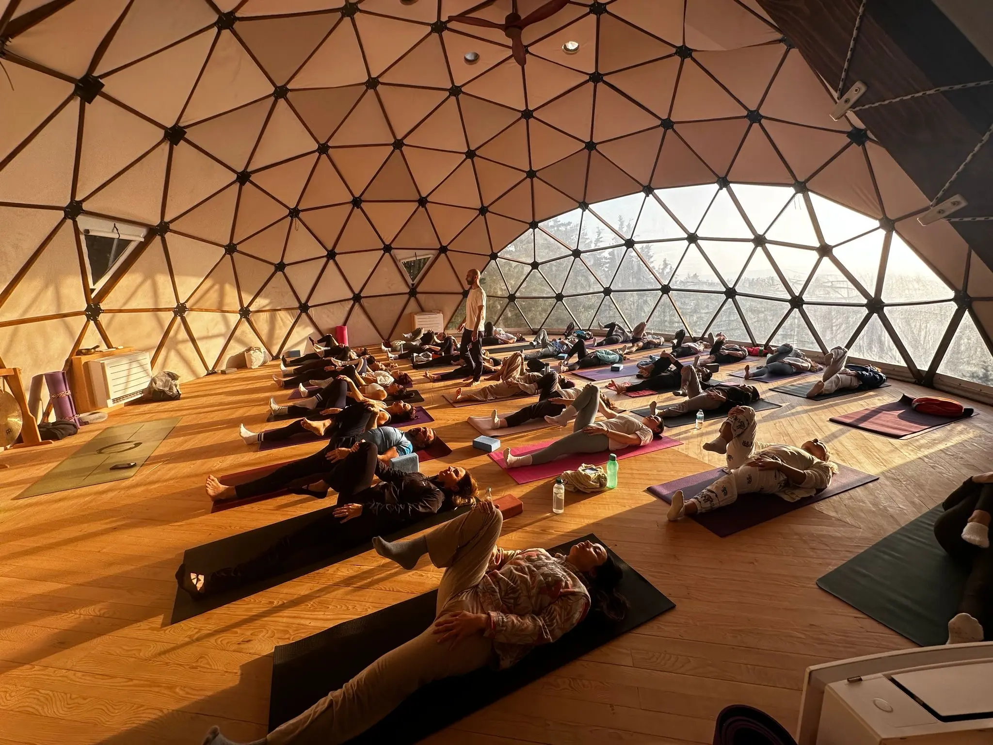A yoga class resting in the geodesic dome at Çeşmeköy in warm afternoon light