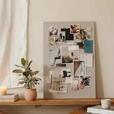 A completed vision board on a shelf beside a plant and candle
