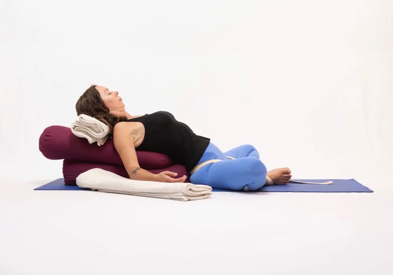 Restorative yoga pose with bolsters and props